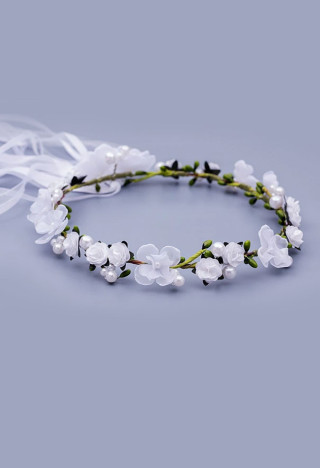 delicate garland with white flowers and green elements and beautiful ribbons on the back