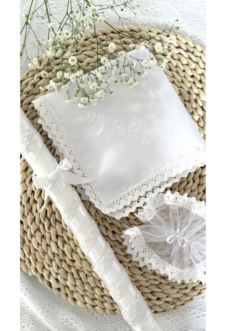 A classic christening candle – white, decorated with lace and ribbon.