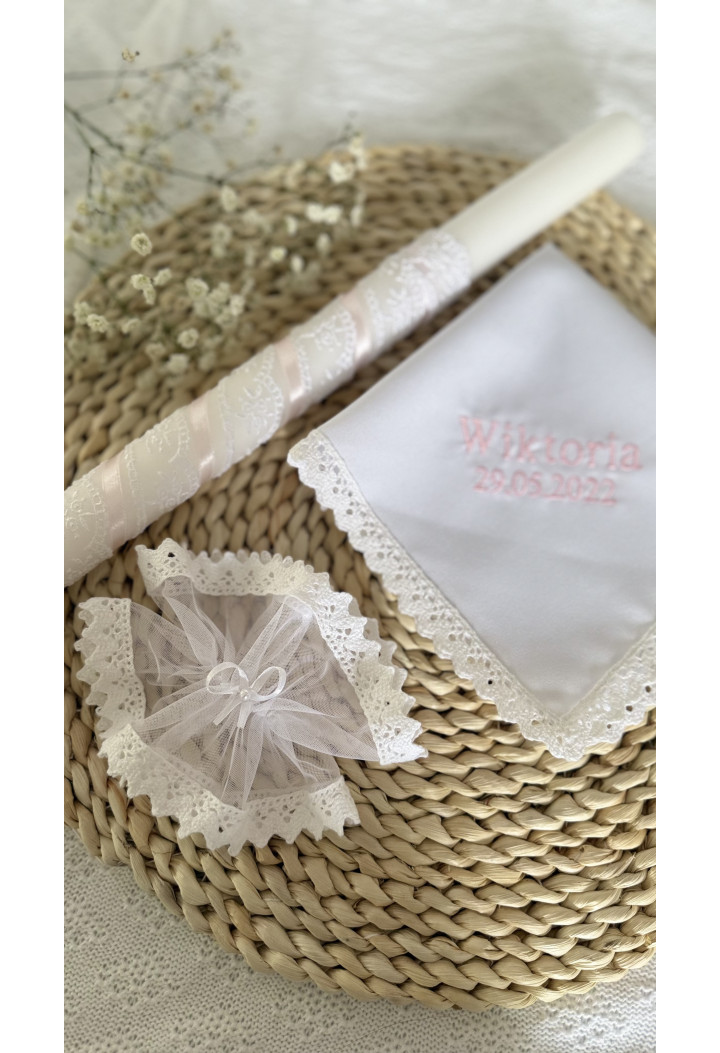 A classic christening candle – pink, decorated with lace and ribbon.