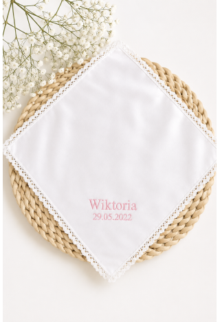 A baptismal gown for a girl with her name and baptism date in pink embroidery